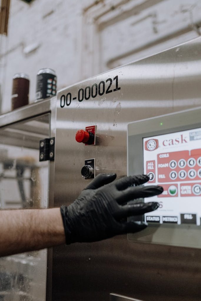 Engineer using a touchscreen interface on a metal manufacturing machine.